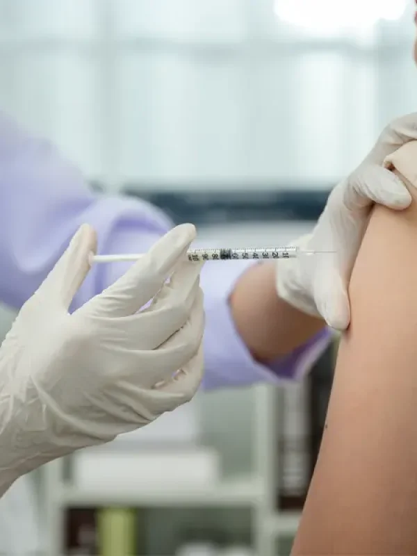 A girl getting im injection in arm